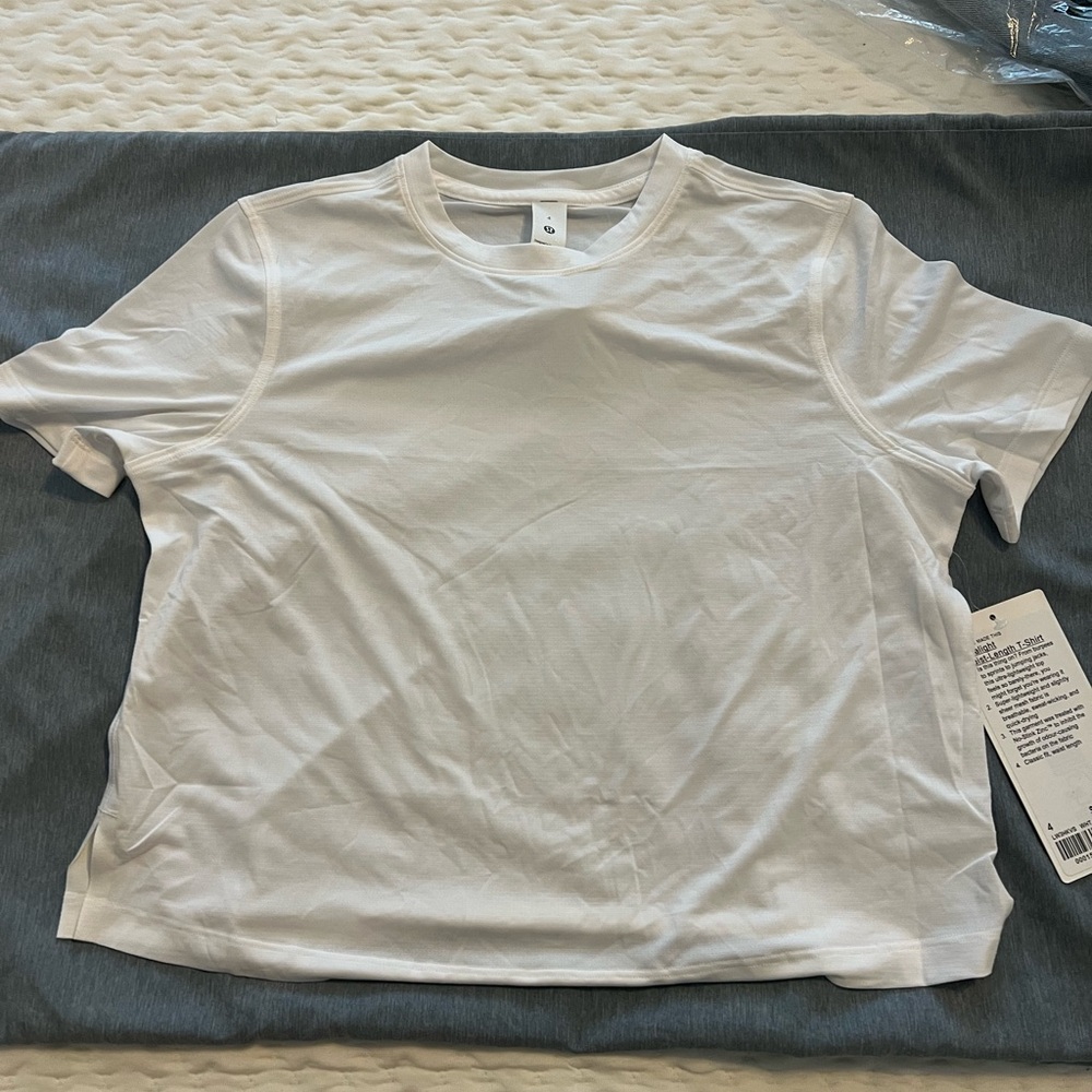 Lululemon ultralight waist length tee size 4. Small makeup on neck.can be washed
